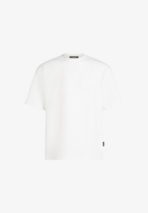 T-shirt court à manches courtes blanc avec un motif texturé de lettres. Encolure ronde et petite étiquette sur l'ourlet inférieur. Matière en mélange de coton.