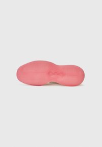 Shoe sole with a textured design, primarily pink with a smooth surface. Features a central pattern and curved edges for flexibility.