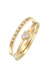 Guldfarvede ringe med forskellige små runde sten. Den ene har tre klumpede sten i hjerteform, mens den anden har en række af sten.