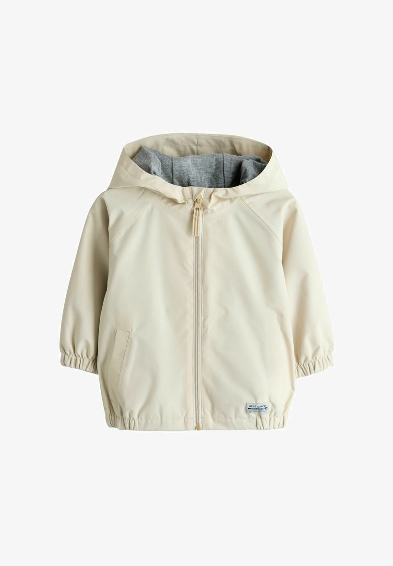 Krém színű kapucnis gyermekdzseki szürke béléssel, elöl cipzárral, elasztikus mandzsettákkal és zsebekkel.
