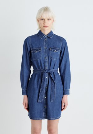 Denim shirt dress, dark blue, long sleeves, button-down front, two chest pockets, belted waist, collar, smooth texture.
