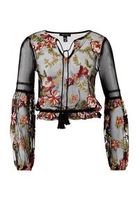 Blusa nera trasparente con motivo floreale ricamato in rosso, arancione e verde. Presenta maniche lunghe, scollo a V e un dettaglio con laccio all'orlo.