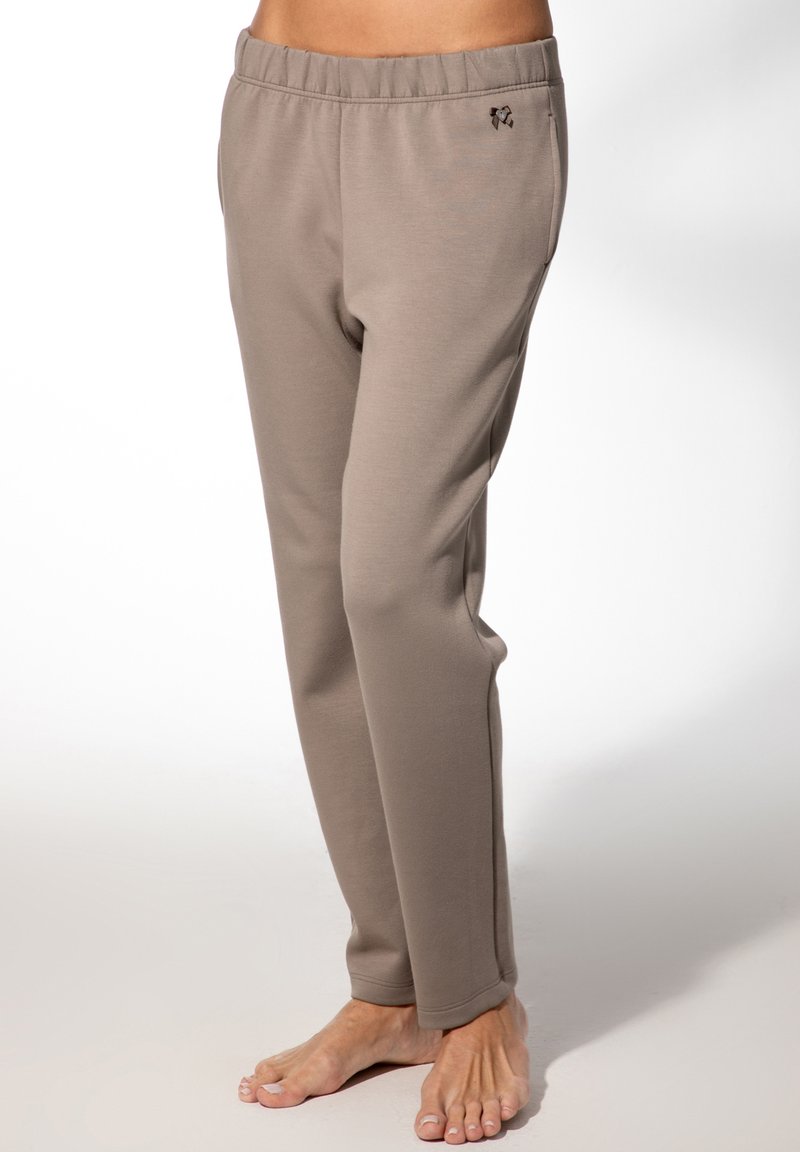 Beige Jogginghose mit elastischem Bund aus weichem Stoff; verfügt über ein kleines Logo in Hüfthöhe und gerade geschnittene Beine.