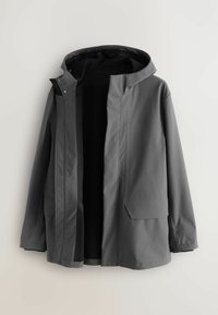 Gray waterproof jacket with a hood, zip closure, and two front pockets. Smooth material with a minimalist design. Interior lining visible.