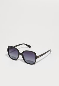 Black oversized sunglasses with a hexagonal frame, gradient lenses, and subtle gold accents on the temples. Made from polycarbonate material.