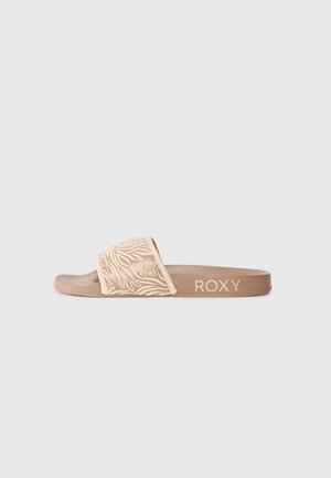 Sandale à enfiler avec une bande beige texturée ornée de motifs floraux et une semelle marron. Logo "ROXY" imprimé sur le côté.