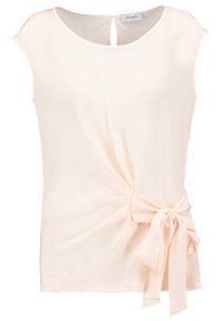 Blouse crème sans manches avec encolure ronde et détail nœud sur le côté, sur fond uni.