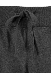 Gray sweatpants feature a ribbed waistband with a drawstring. The fabric appears soft with a smooth texture and a slight sheen.