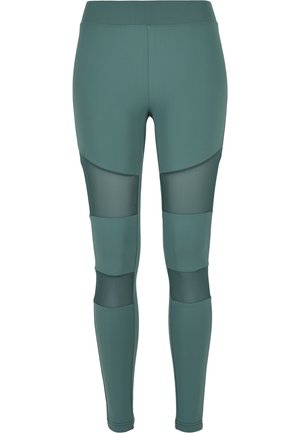 Green leggings featuring a stretchy fabric, high waistband, and mesh panels, with a fitted design and curved accent details.