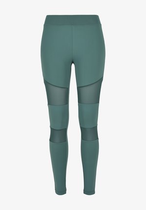 Zöld leggings rugalmas anyagból, magas derekú kialakítással és hálós panelekkel, testhezálló dizájnnal és ívelt díszítőelemekkel.