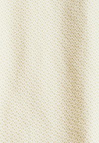 Geometrisch gemusterde stof in lichtcrème met subtiele tan motieven. Soepele textuur met een consistente weefstructuur door het materiaal.