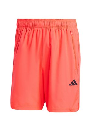 Neon oranssit urheiluhousut, joissa on joustava vyötärö, kaksi vetoketjullista sivutaskua ja musta Adidas-logo vasemmassa alakulmassa.