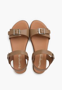 Brown leather sandals with two adjustable straps, a metal buckle accent, and a flat sole. Embossed logo on the insole.