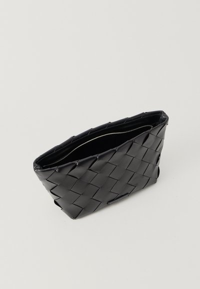 Sort flettet læder clutchtaske med lynlåslukning. Har et stripet mønster og glat inderside. Rektangulær form, ingen håndtag.