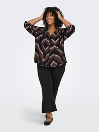 Brown and black patterned blouse with a V-neck, three-quarter sleeves, and button closure. Paired with black flared trousers and flats.