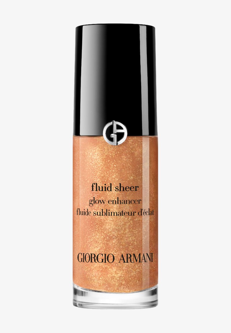 Giorgio Armani Fluid Sheer glitrende forsterker i en klar flaske med svart lokk. Væsken har en varm, glitrende gyllen farge med en jevn tekstur.
