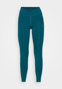 Teal leggings med hög, korsad midja. Tillverkade av ett mjukt och stretchigt material. Har en diskret logotyp på vänster sida.