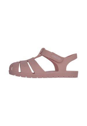Sandali di gomma rosa con design traforato, cinturino regolabile e suola testurizzata. Marcati con etichetta "CHICCO" sul lato.