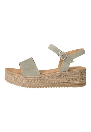 Zielona zamszowa sandał na koturnie z dwoma szerokimi paskami, regulowanym paskiem na kostkę i plecioną juty. Gładka tekstura z amortyzującą wkładką.