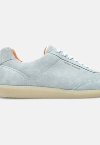 Light blue suede sneaker with a rounded shape, white laces, and a beige heel tab. Features a textured rubber sole and "HENRY STEVENS" logo.