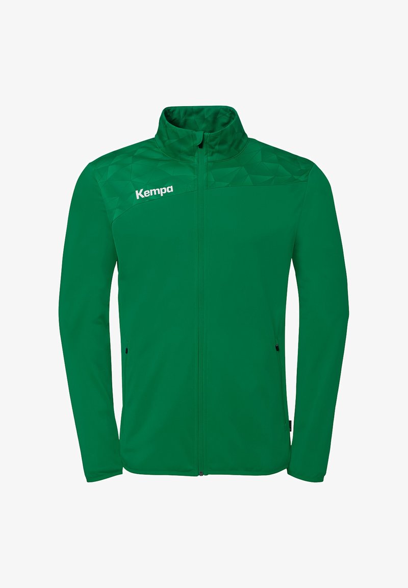 Veste de sport verte à fermeture éclair intégrale avec motif géométrique sur les épaules, col montant, poches latérales zippées et logo "Kempa" sur la poitrine gauche.