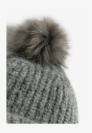 Gray knitted beanie featuring a soft, fluffy gray pom-pom on top. The textured pattern consists of raised, ridged stitches.