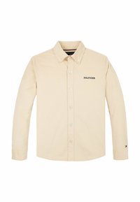 Be�żowa koszula z długim rękawem, zapinana na guziki, z kołnierzykiem zapinanym na guziki, z napisem "HILFIGER" na klatce piersiowej i małym logo Tommy Hilfiger na lewym mankiecie.