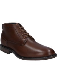 Botte de cheville en cuir marron avec une texture lisse, bout rond, design à lacets et semelle foncée contrastante. Présente des détails de couture subtils.