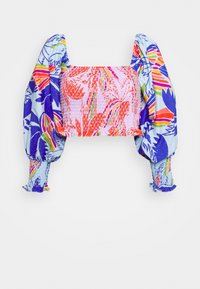 Top court à manches longues bouffantes, présentant des motifs floraux abstraits colorés en rose, bleu, orange, vert et violet sur fond blanc.