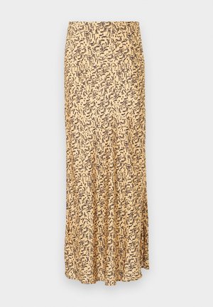 Beige lang nederdel med sort abstrakt penselstrøgsmønster, lige snit og let flæse forneden mod en ensfarvet lys grå baggrund.