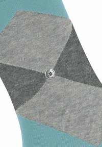 Chaussette à motifs argyle vert d'eau et gris, avec une texture lisse, présentant un logo circulaire sur la partie supérieure.