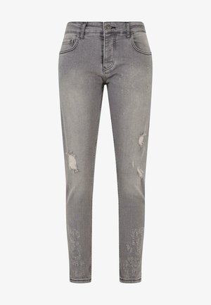 Grijze denim jeans met een strakke pasvorm, voorzien van versleten plekken en rafelige accenten op de dijen. Standaard knoop- en rits sluiting.
