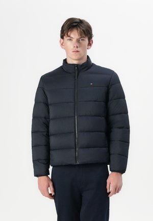 Black puffer jacket with a high collar and horizontal stitching. Features a front zipper and small logo detail on the left chest.