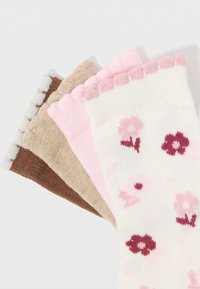 Quattro paia di calzini: crema con motivo floreale, rosa, beige e marrone. Polsini a coste in colori a contrasto. Morbido, texture lavorato a maglia.