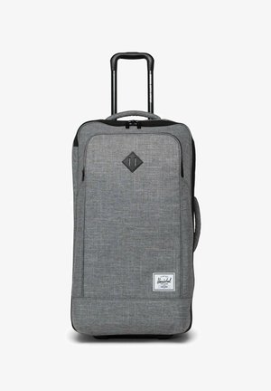 Valise à roulettes souple grise avec poignée rétractable, poche zippée avant, poignée latérale et étiquette de marque Herschel sur le bas à l'avant.
