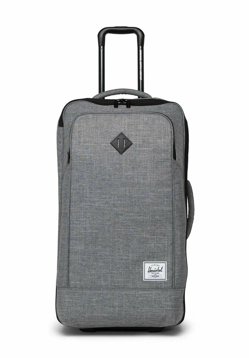 Valise à roulettes souple grise avec poignée rétractable, poche zippée avant, poignée latérale et étiquette de marque Herschel sur le bas à l'avant.