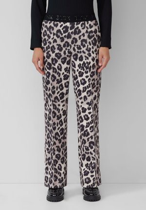 Leopard print wide-leg pants made of soft fabric with a black elastic waistband featuring embossed text. Smooth texture, neutral color palette.