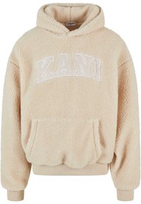 Felpa con cappuccio beige in fleece, dotata di tasca a marsupio, con la scritta 'KANI' ricamata in lettere bianche sul petto e polsini e orlo a coste.