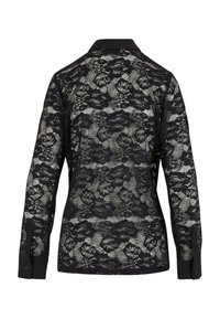 Chemise noire à manches longues boutonnée avec motif en dentelle florale, col uni et poignets, vue de dos sur fond blanc.