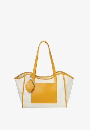Torba typu tote w kolorze kremowym i musztardowym z dwoma długimi uchwytami, przednią kieszenią oraz małą, przymocowaną sakiewką na monety zawieszoną na jednym uchwycie.