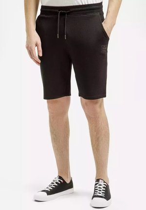 Czarne szorty z mieszanki bawełny z elastycznym paskiem w talii, sznurkiem, bocznymi kieszeniami i małą łatką z logo z przodu. Zaprojektowane do codziennego noszenia.