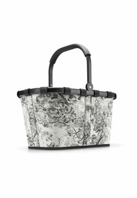 Panier fourre-tout à motifs noir et blanc avec un design incurvé, en tissu texturé et doté d'une robuste poignée noire, présentant un imprimé botanique détaillé.