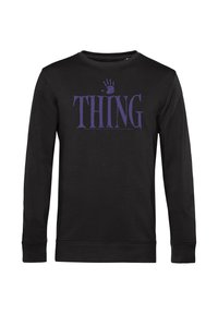 Felpa nera a maniche lunghe con un'impronta di mano viola sopra la parola "THING" sul petto.
