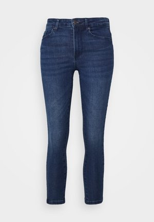 Donkerblauwe high-waist skinny jeans met knoop- en ritssluiting aan de voorkant, vijf zakken en subtiele vervaging op de dijen en knieën.