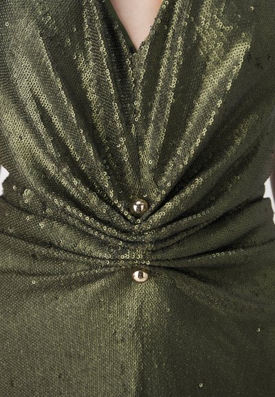 Green sequined dress featuring a deep V-neck and a twisted design at the waist, accented with gold buttons for added detail.