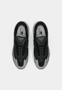 Black and gray New Balance 1000 running sneakers shown from above on a white background, side-by-side with laces tied.