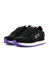 Black sneakers featuring a mix of suede and mesh, with a white and purple sole, and pink accents on the tongue and logo.