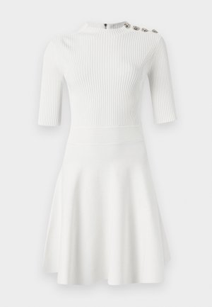 Weißes, geripptes Kleid mit kurzen Ärmeln, hohem Kragen, figurbetontem Oberteil, schwingendem Rock und drei dekorativen Knöpfen an einer Schulter. Glatte Textur.