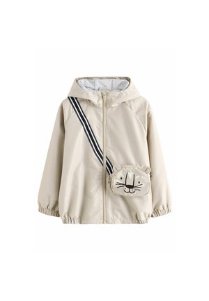 Veste beige à capuche avec fermeture éclair à l'avant et poignets élastiques, comprenant un petit sac bandoulière attaché avec un visage d'animal souriant et des oreilles.