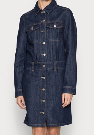 Dark blue denim dress with long sleeves, front button closure, collar, two chest flap pockets, and contrast stitching, worn by a woman.